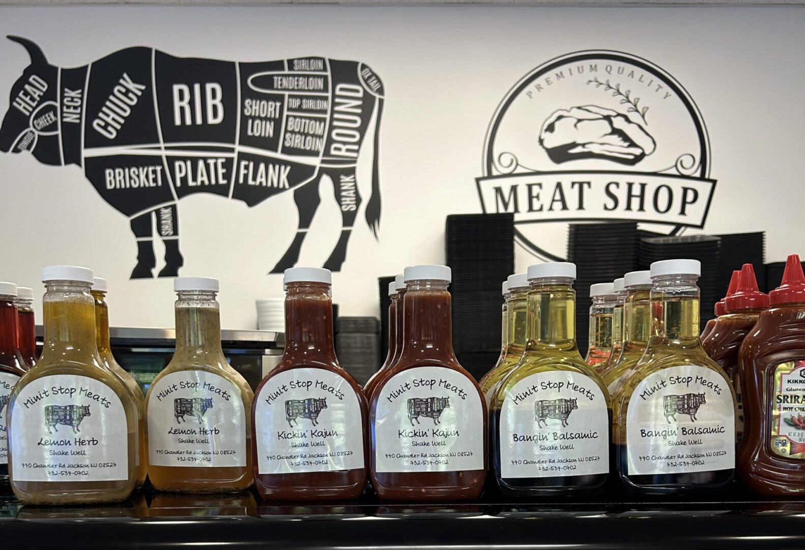 A shelf with several different types of meat sauces.