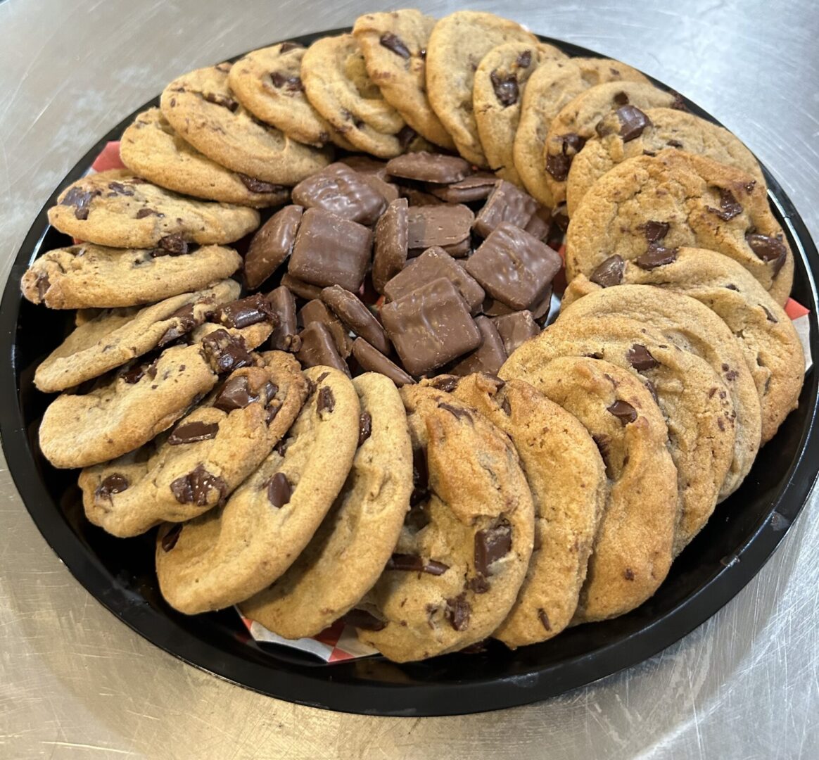 A tray of cookies and chocolate chips on top of a table.