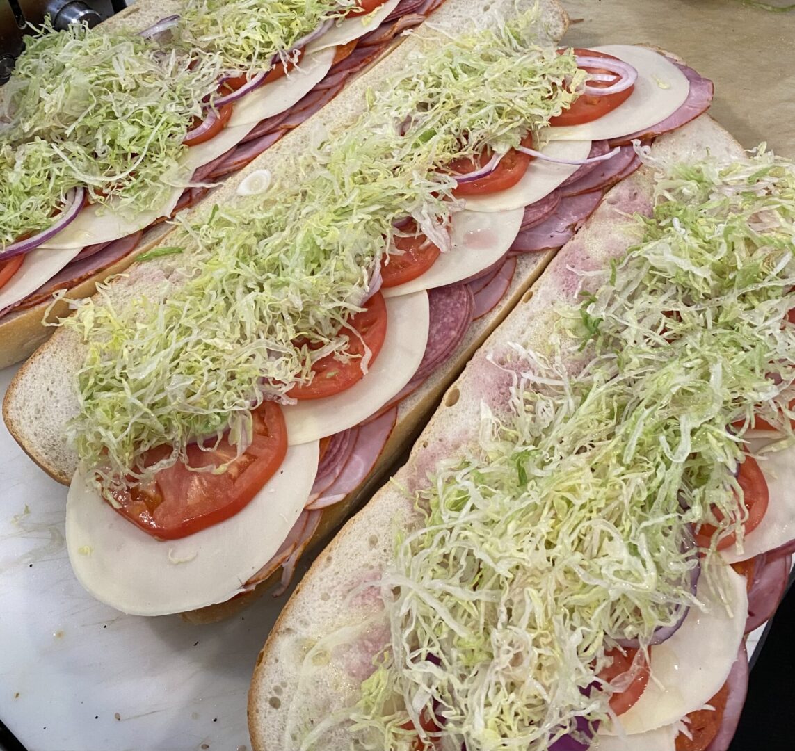 A close up of three sandwiches with toppings