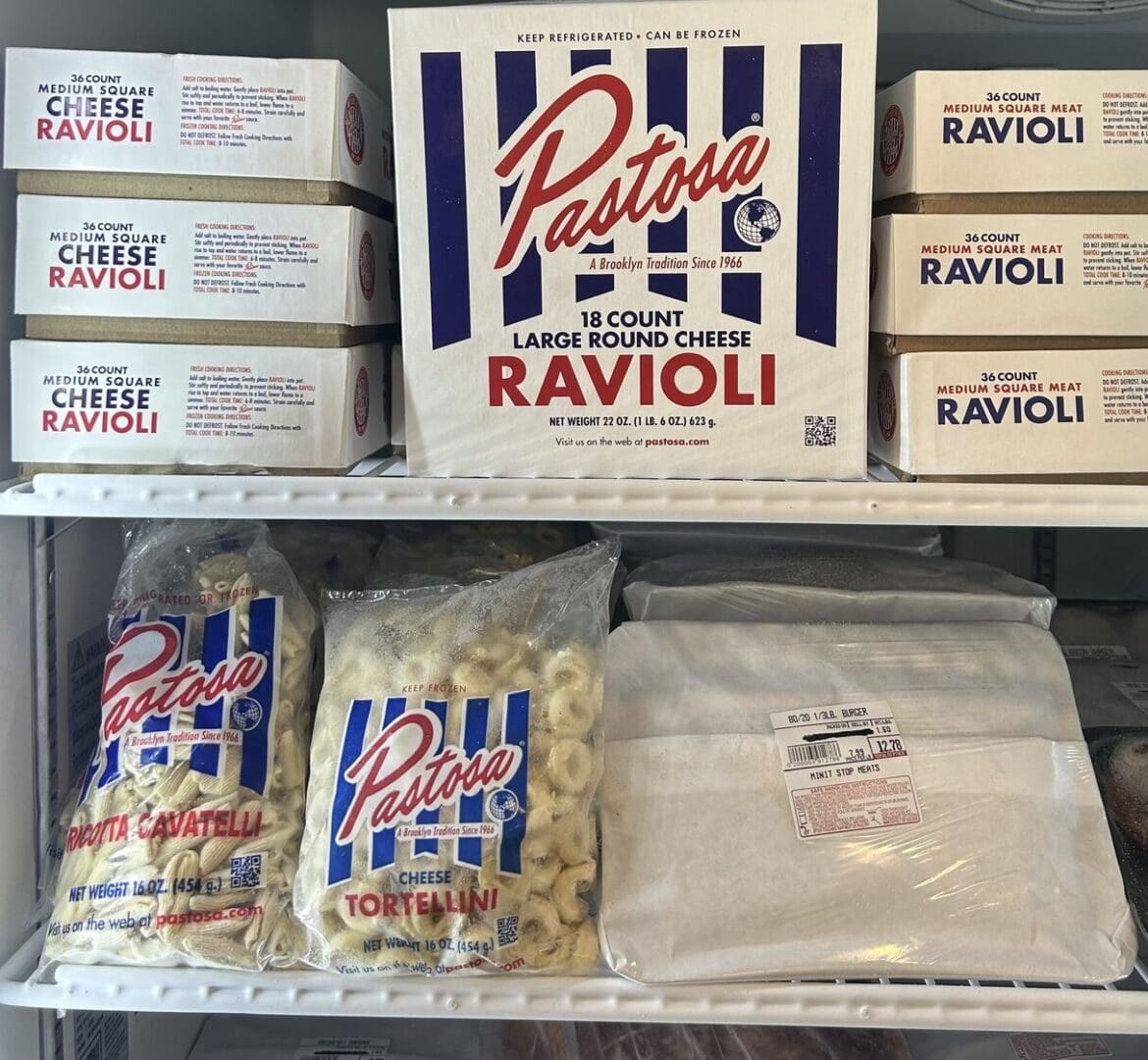 A refrigerator filled with pasta and bags of cheese.